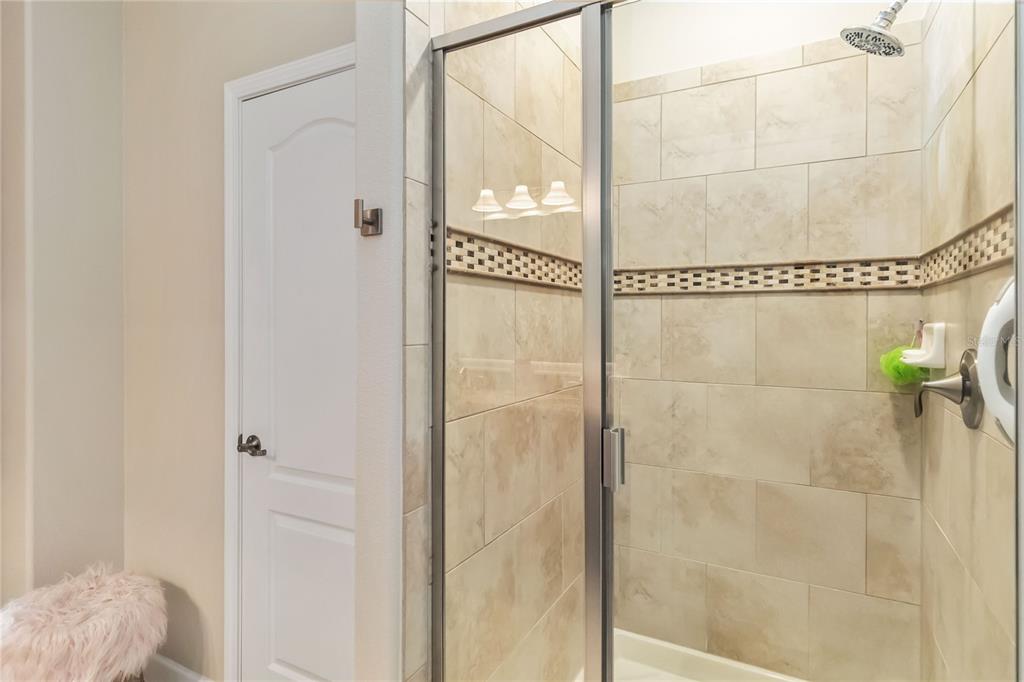 6805 Sundrop Street Harmony, FL 34773 - Photo 16 of 24 a bathroom with a shower and a window