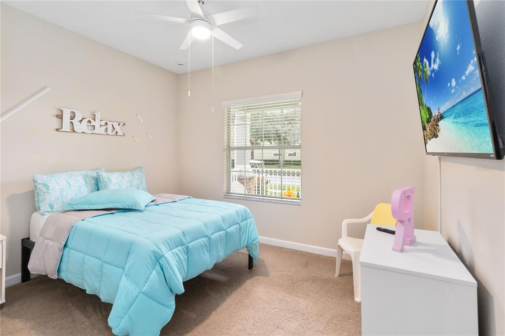6805 Sundrop Street Harmony, FL 34773 - Photo 17 of 24 a bedroom with a bed and a window