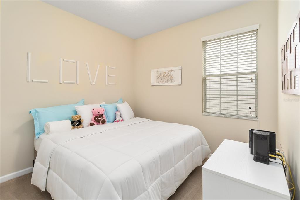 6805 Sundrop Street Harmony, FL 34773 - Photo 19 of 24 a bedroom with a bed and a window