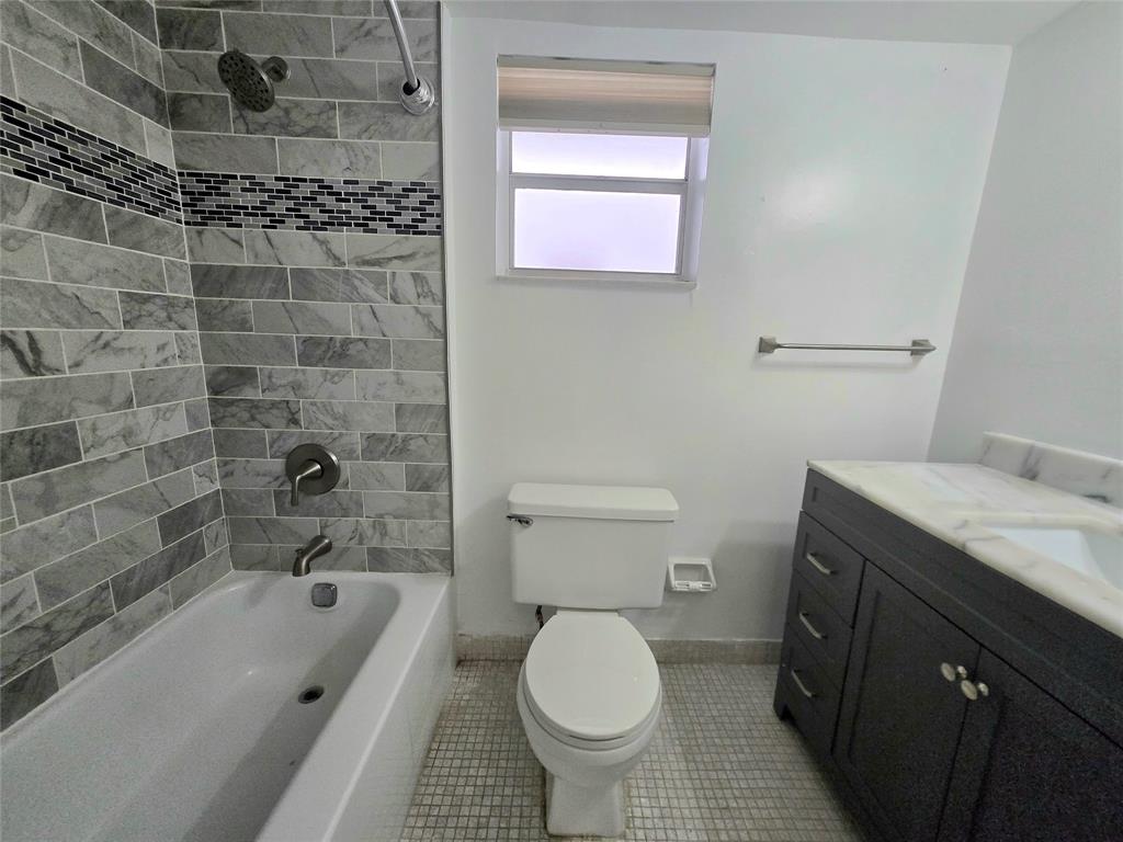 6503 Winfield Boulevard, Unit 107D Margate, FL 33063 - Photo 15 of 24 a bathroom with a sink a toilet and shower