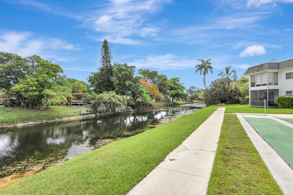 6503 Winfield Boulevard, Unit 107D Margate, FL 33063 - Photo 18 of 24 a view of a lake with a yard