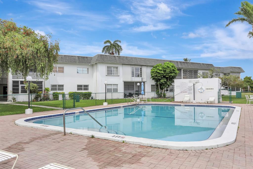 6503 Winfield Boulevard, Unit 107D Margate, FL 33063 - Photo 20 of 24 a view of a house with a swimming pool