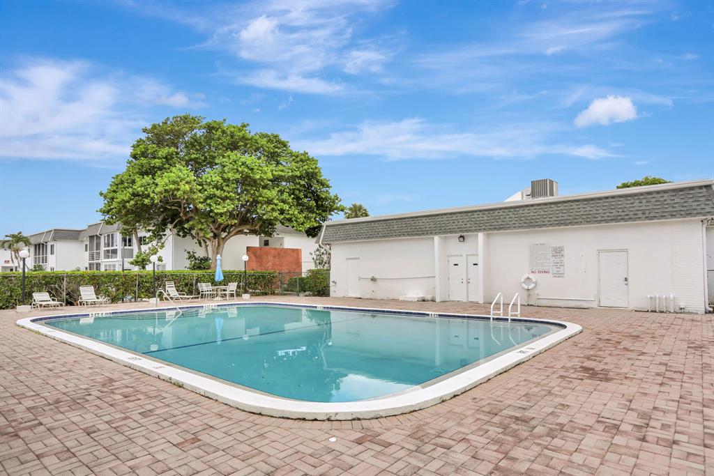 6503 Winfield Boulevard, Unit 107D Margate, FL 33063 - Photo 21 of 24 a view of a house with a swimming pool