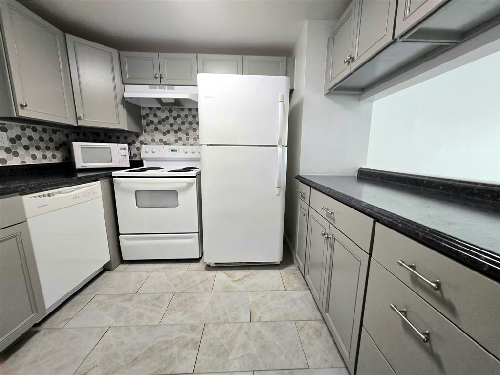6503 Winfield Boulevard, Unit 107D Margate, FL 33063 - Photo 3 of 24 a white refrigerator freezer sitting in a kitchen