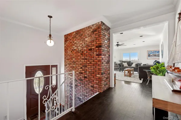 a living room with furniture stairs and a chandelier