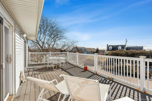 a view of balcony with wooden floor and fence