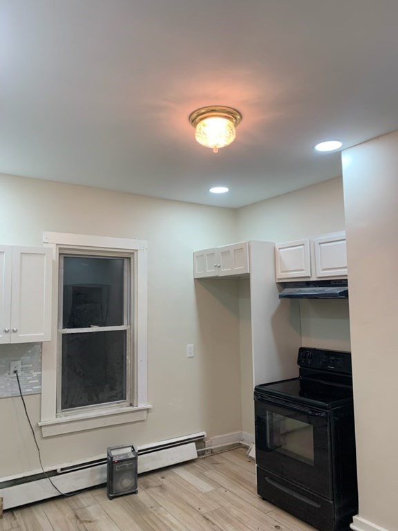 10 Bryant Street, Unit 2 Taunton, MA 02780 - Photo 3 of 8 an empty room with wooden floor and windows