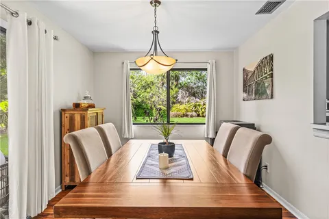 a view of a dining room with furniture window and outside view