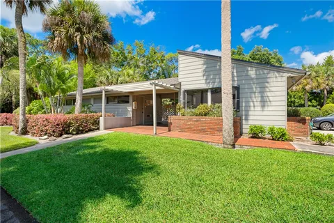 a view of a house with a backyard and a patio