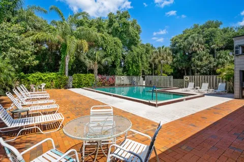 a view of a house with swimming pool and sitting area