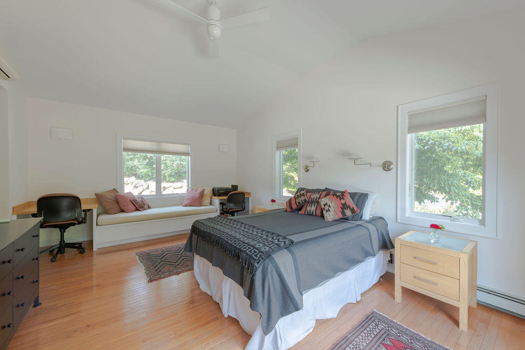 10 Hamblen Farm Road Wellfleet, MA 02667 - Photo 19 of 59 a bedroom with a bed and a chair