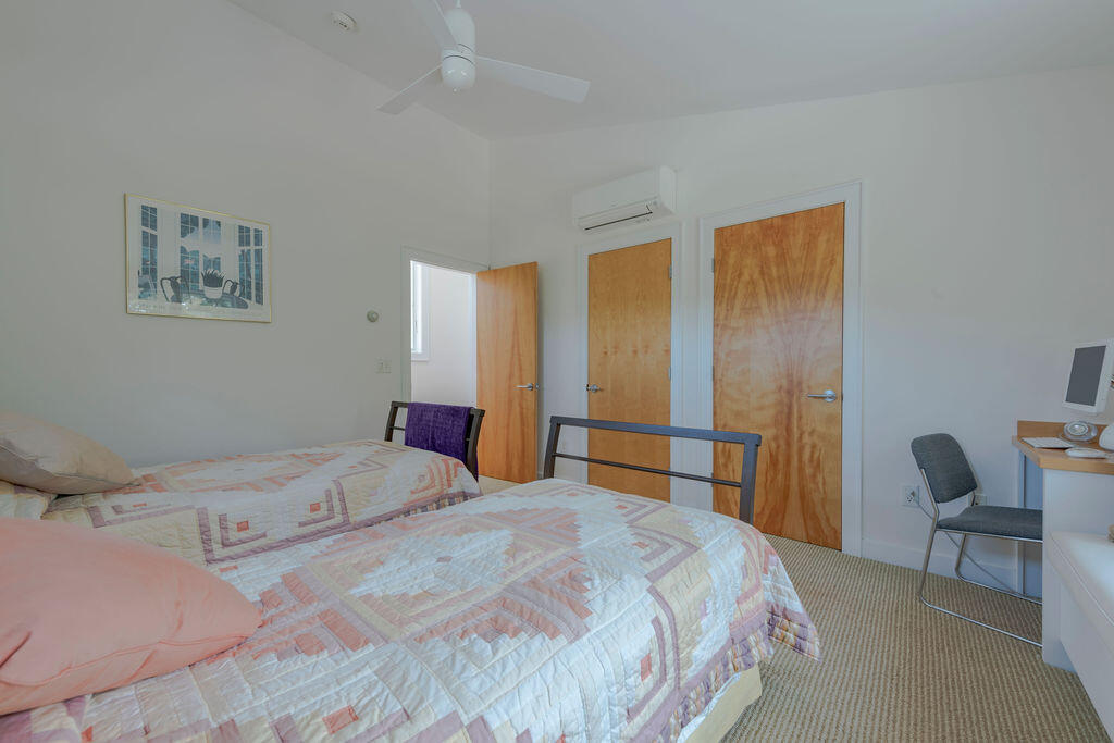 10 Hamblen Farm Road Wellfleet, MA 02667 - Photo 26 of 59 a bedroom with a bed a chair and a large mirror next to a window