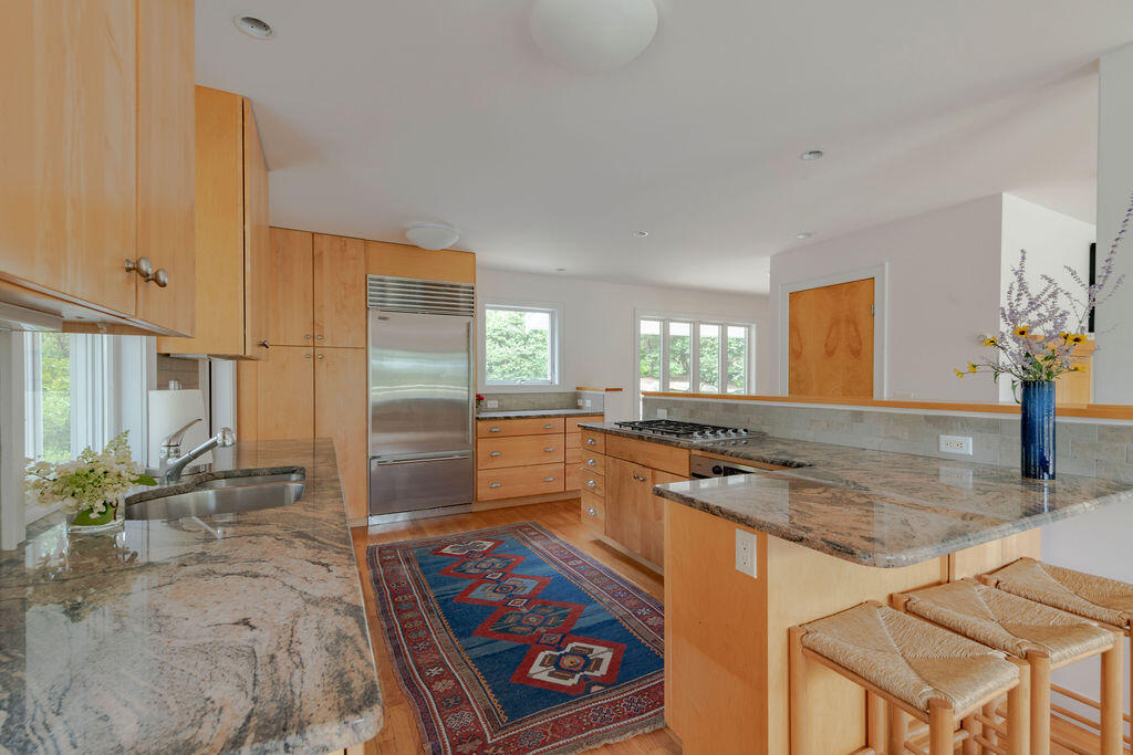 10 Hamblen Farm Road Wellfleet, MA 02667 - Photo 3 of 59 a kitchen with stainless steel appliances granite countertop a sink stove and cabinets