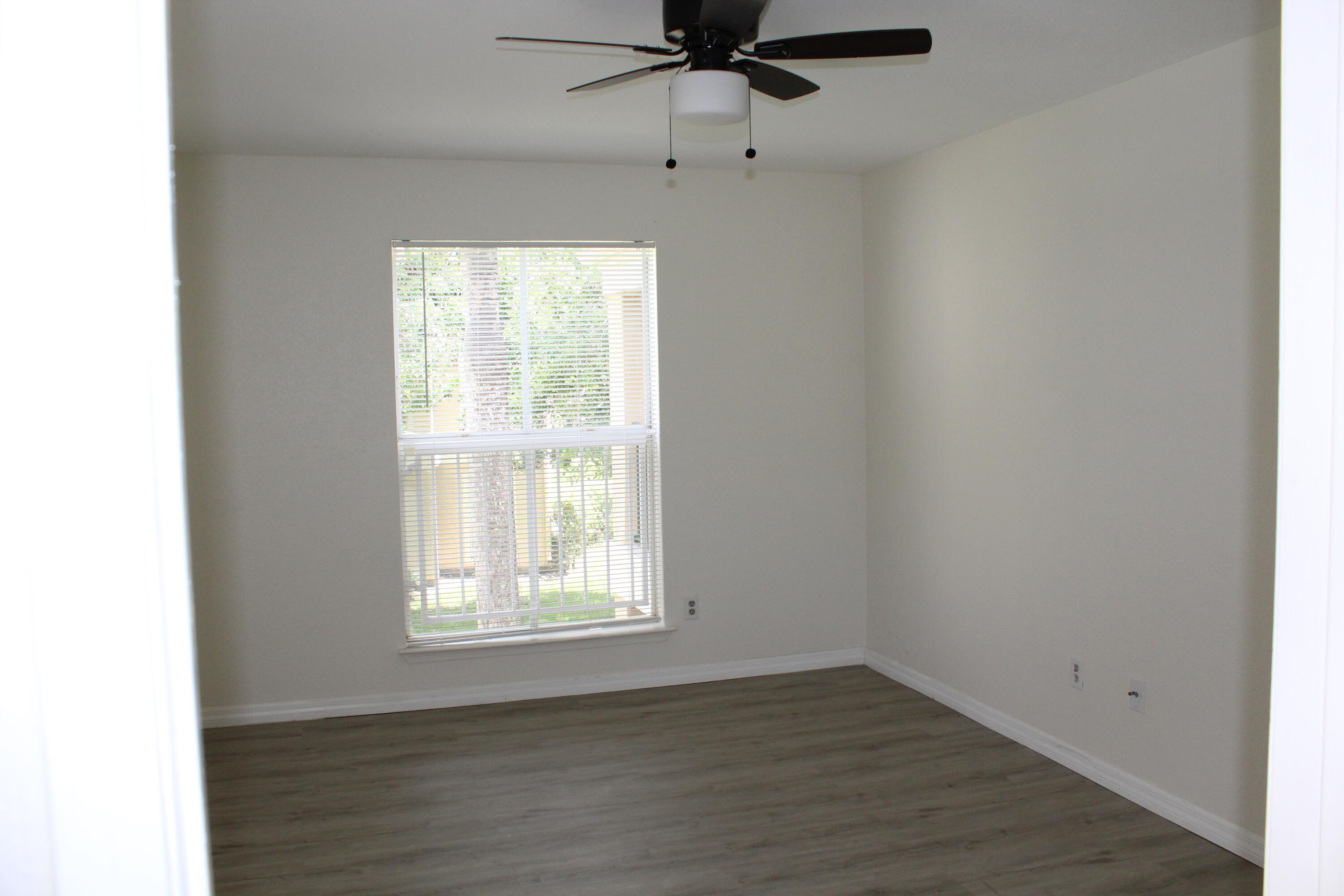 899 Riverside Drive, Unit 620 Coral Springs, FL 33071 - Photo 34 of 46 a view of an empty room with wooden floor and a window