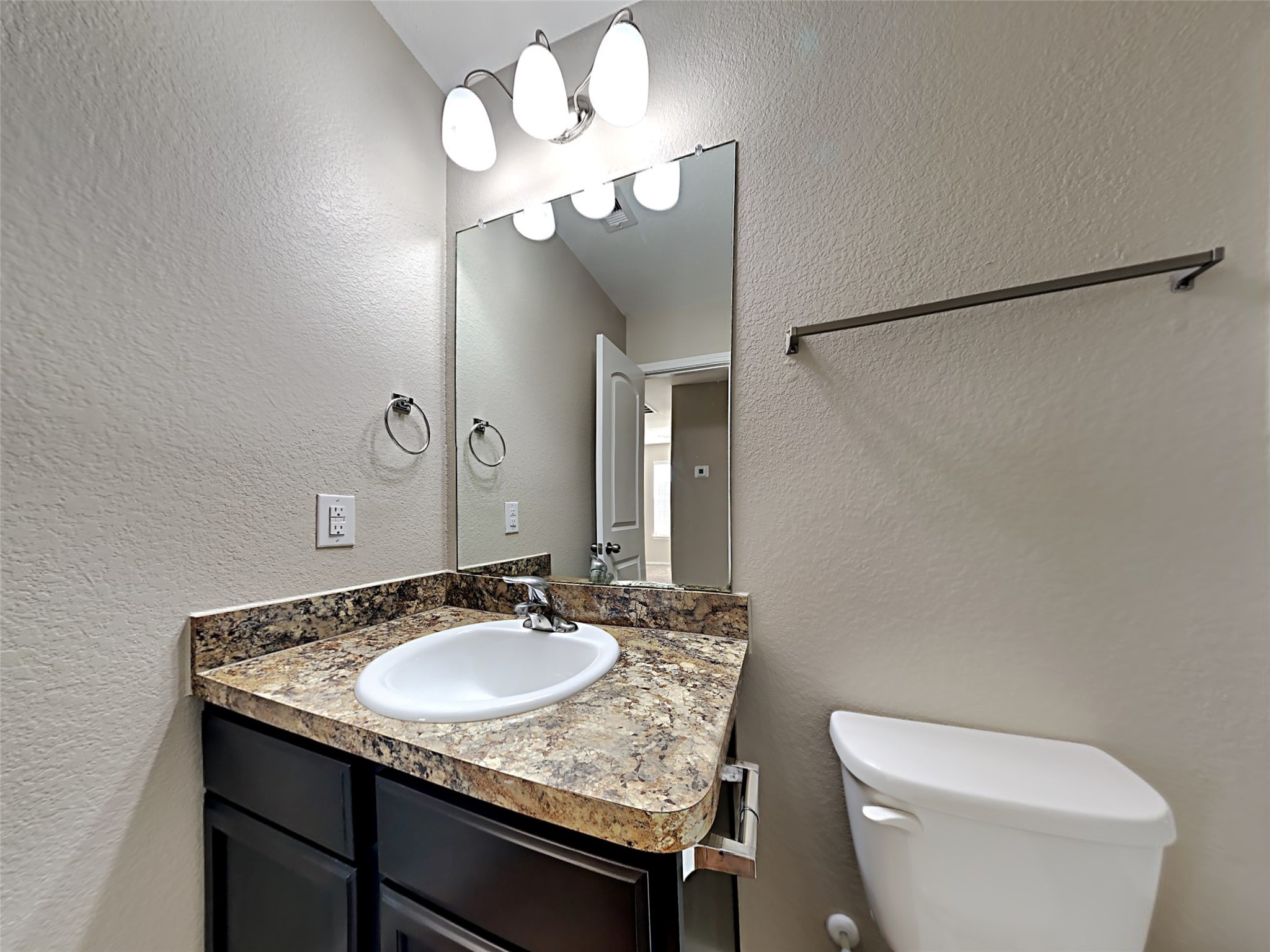 15451 Refugio Verde Way Houston, TX 77049 - Photo 14 of 20 a bathroom with a granite countertop sink and a mirror