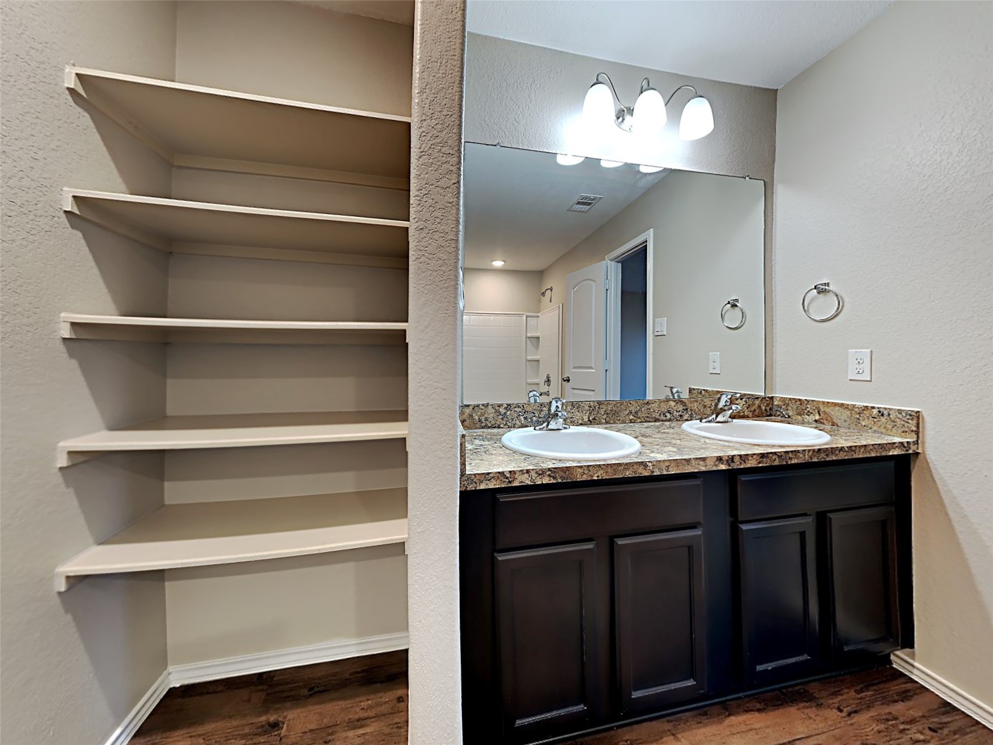 15451 Refugio Verde Way Houston, TX 77049 - Photo 2 of 20 a bathroom with a double vanity sink and a mirror