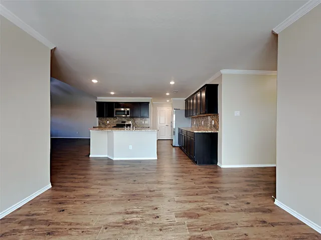 a view of a kitchen with a sink and a refrigerator