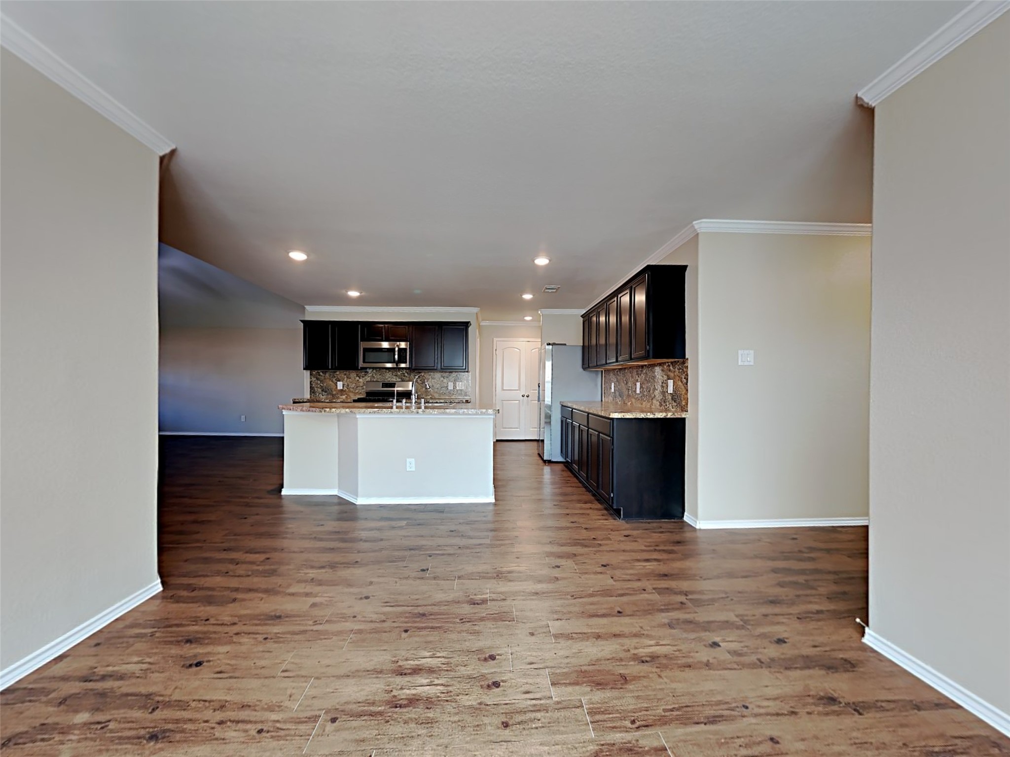 15451 Refugio Verde Way Houston, TX 77049 - Photo 7 of 20 a view of a kitchen with a sink and a refrigerator
