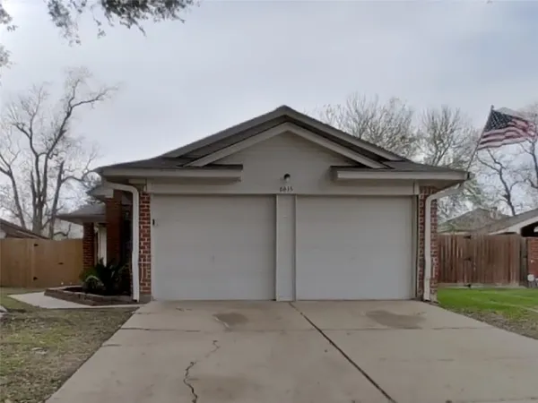 a front view of a house with yard and garage