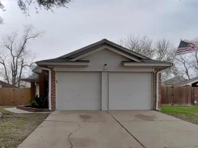a front view of a house with yard and garage