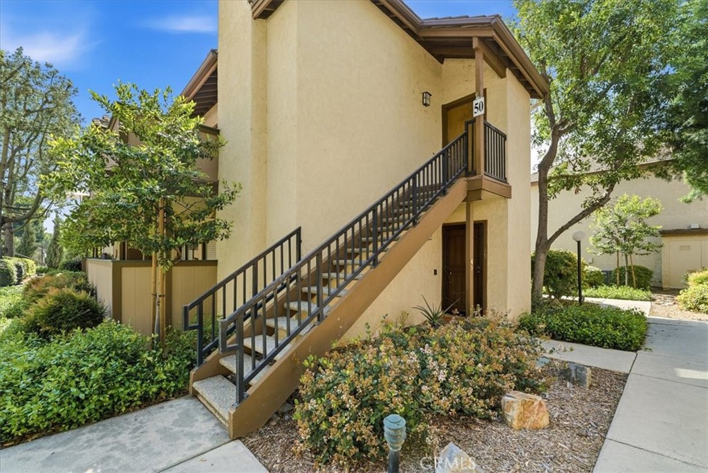 600 North Brea Boulevard, Unit 50 Brea, CA 92821 - Photo 1 of 1 a view of a house with large windows and flower plants
