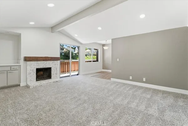 a view of an empty room with a fireplace