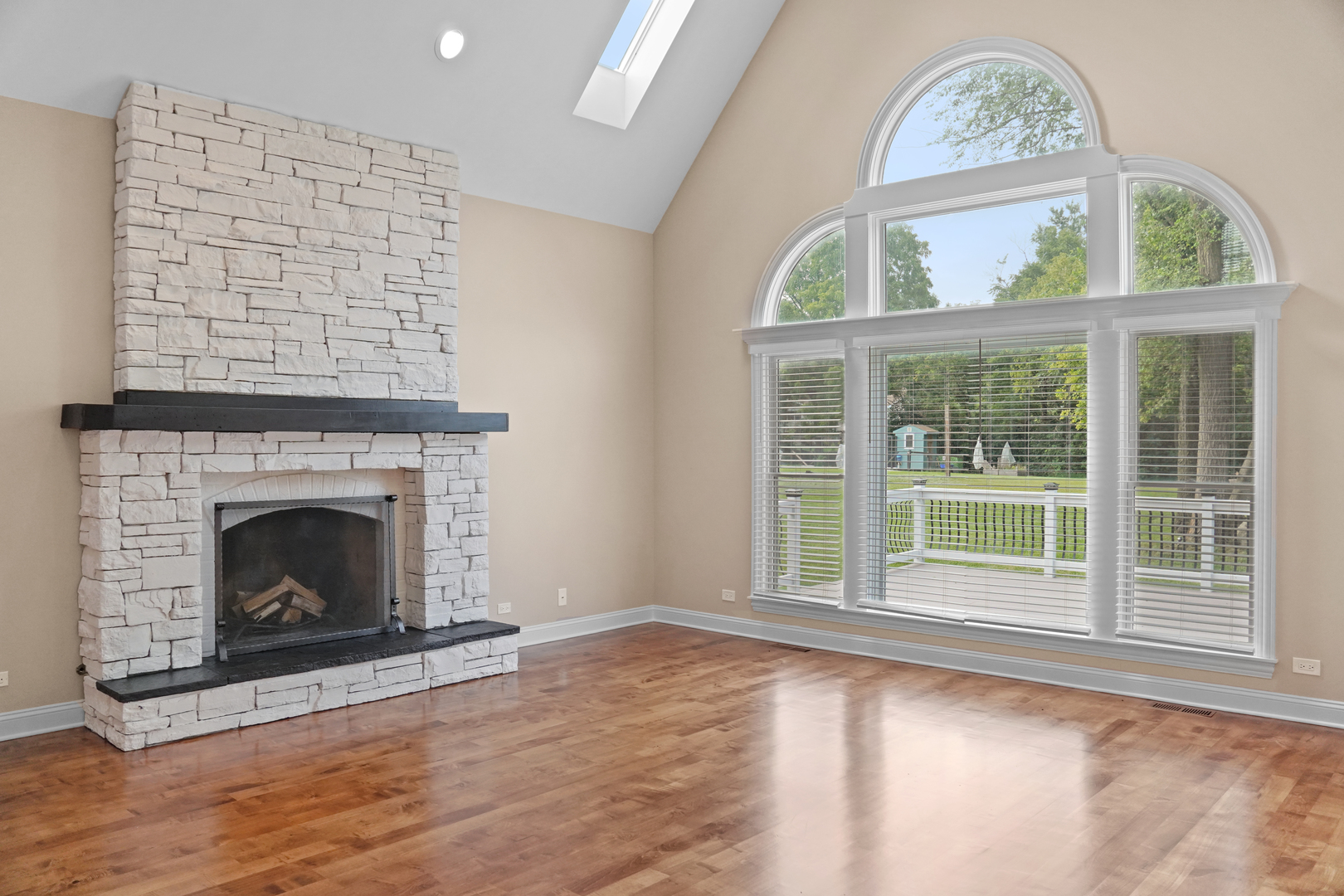 28798 Rivers Edge Drive Cary, IL 60013 - Photo 11 of 46 an empty room with wooden floor a fireplace and windows
