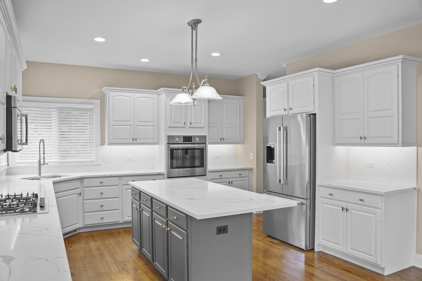 28798 Rivers Edge Drive Cary, IL 60013 - Photo 5 of 46 a kitchen with white cabinets and stainless steel appliances