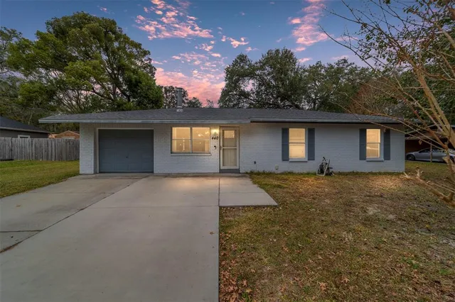 front view of a house with a yard and a garage