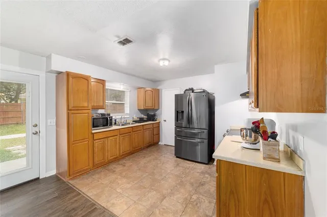 a kitchen with a refrigerator sink and stove top oven