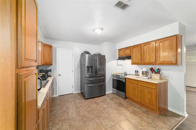 a kitchen with a sink cabinets and stainless steel appliances
