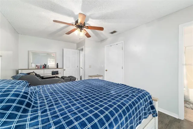 a bedroom with a bed and a chandelier
