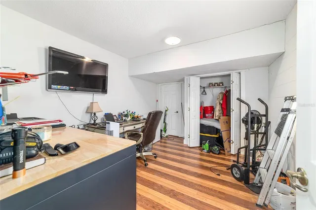 a view of a yard with table and chairs under an umbrella