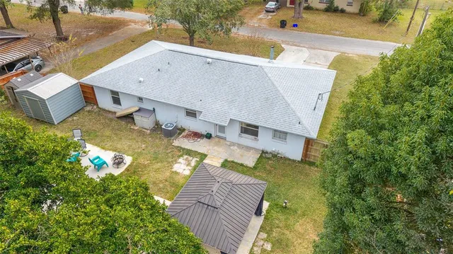 an aerial view of a house with swimming pool