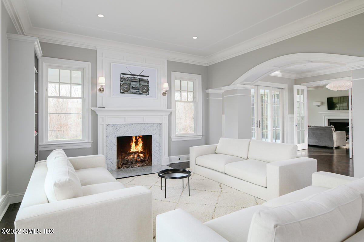 311 Stanwich Road Greenwich, CT 06830 - Photo 12 of 65 a living room with furniture a fireplace and a large window