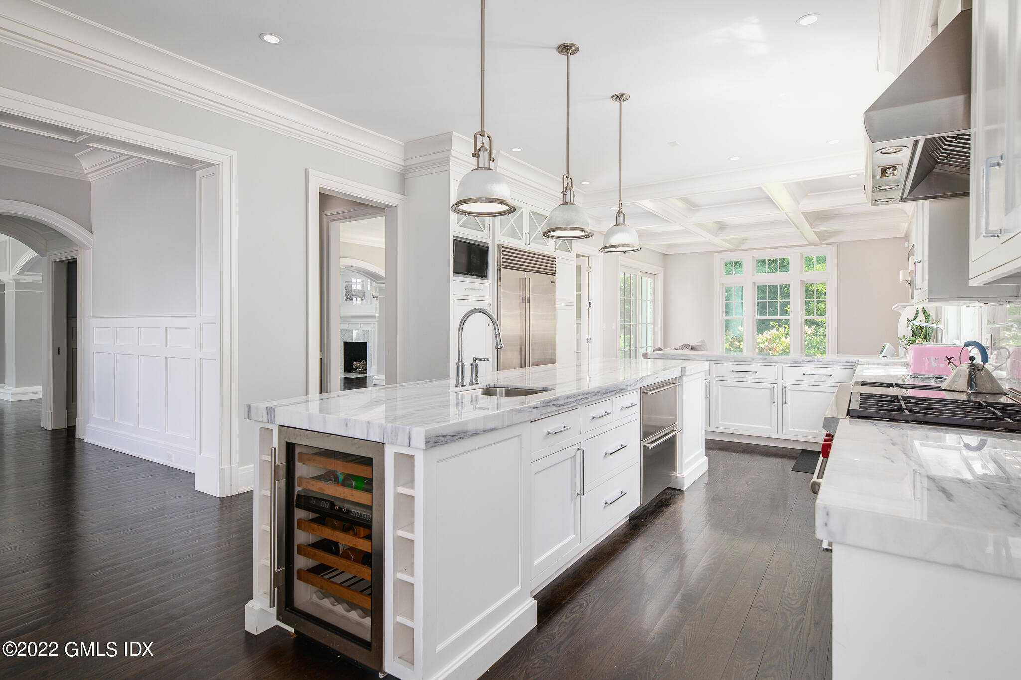 311 Stanwich Road Greenwich, CT 06830 - Photo 20 of 65 a large kitchen with kitchen island a stove a sink a center island and wooden floor