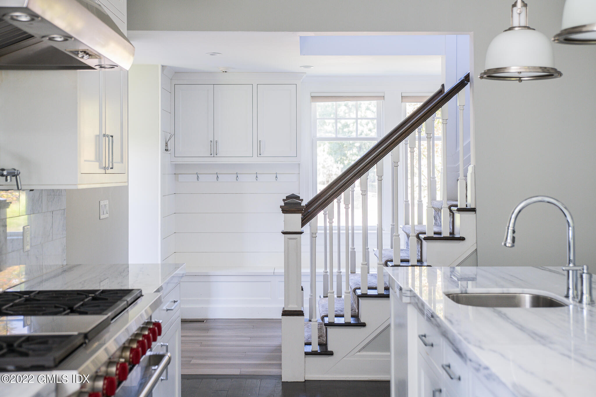 311 Stanwich Road Greenwich, CT 06830 - Photo 23 of 65 a kitchen with granite countertop a sink stove and cabinets