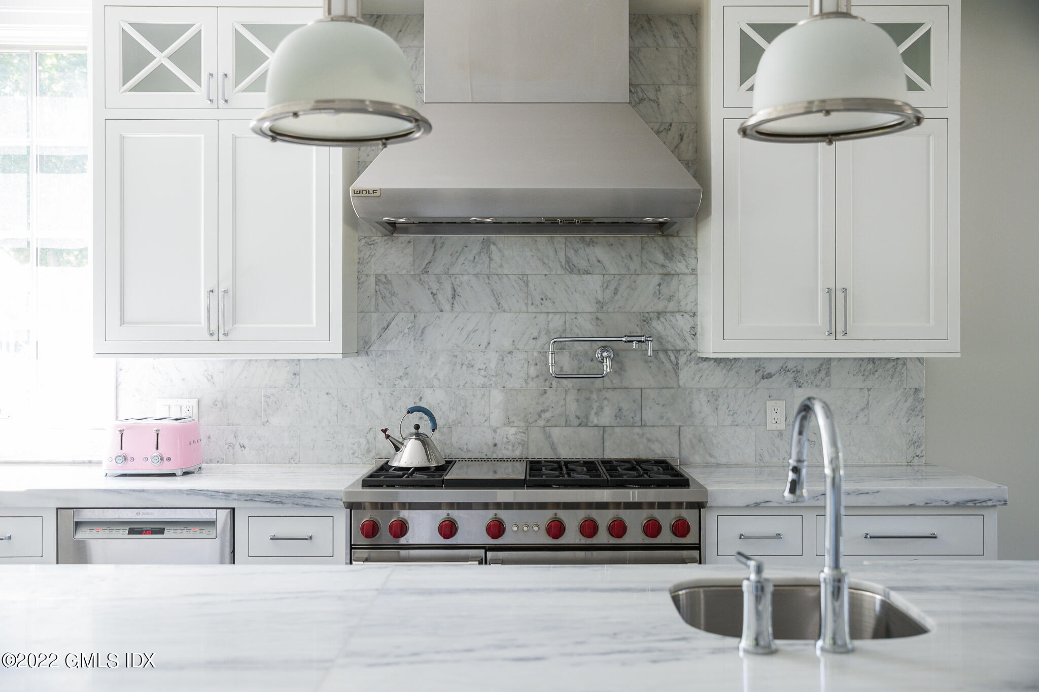 311 Stanwich Road Greenwich, CT 06830 - Photo 24 of 65 a kitchen with a stove and a white wooden cabinets