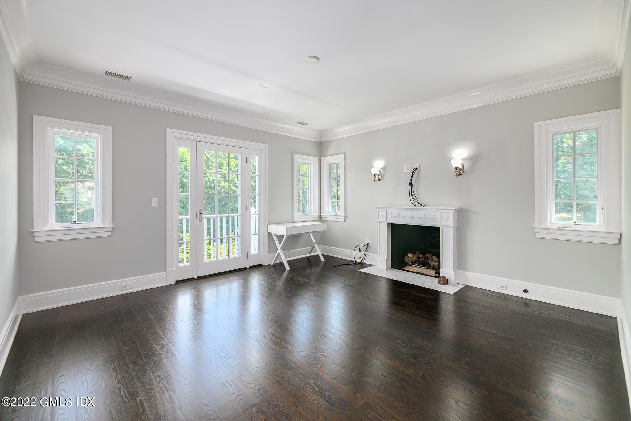 311 Stanwich Road Greenwich, CT 06830 - Photo 35 of 65 a view of an empty room with wooden floor and a window