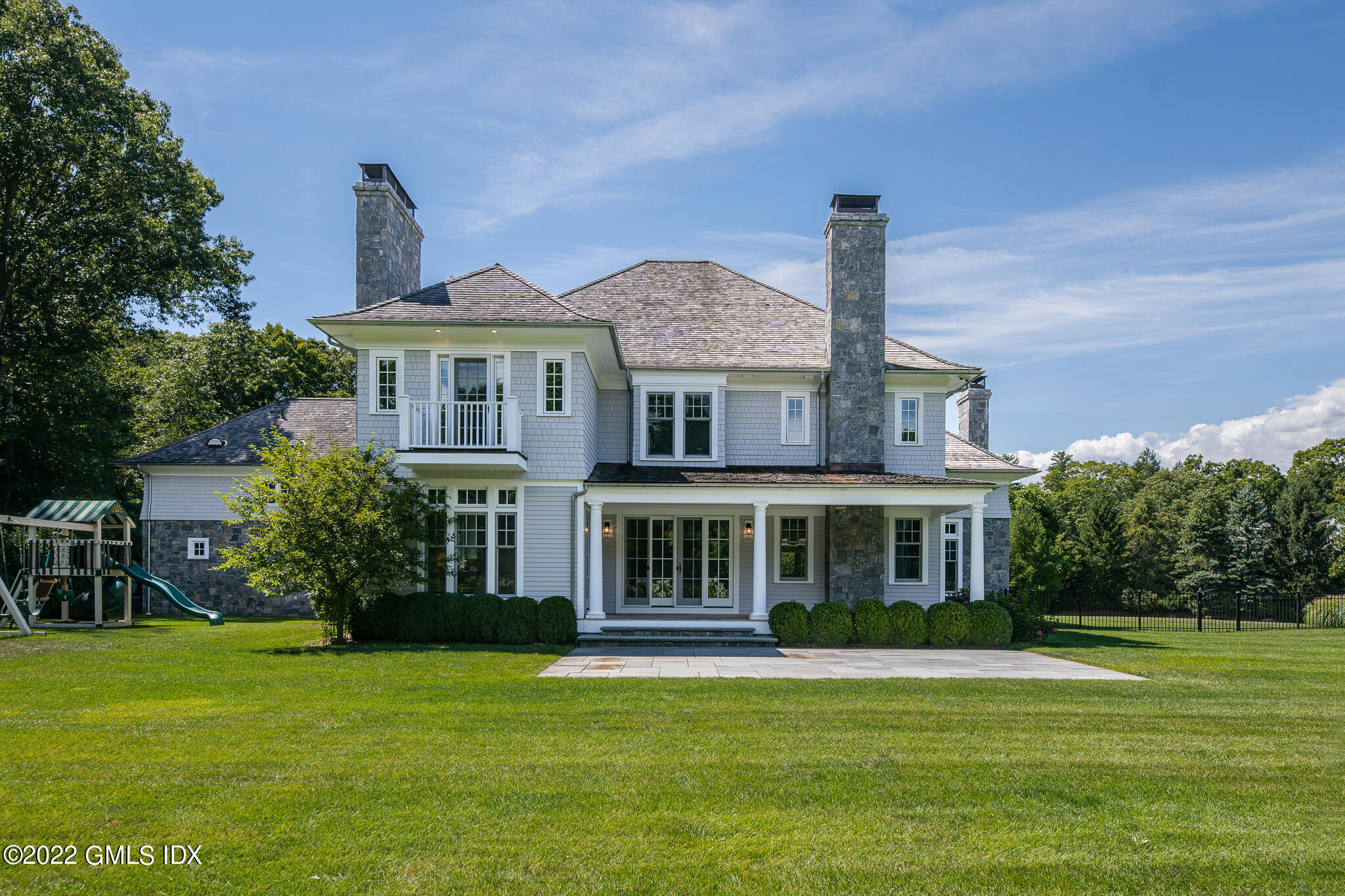 311 Stanwich Road Greenwich, CT 06830 - Photo 58 of 65 a front view of a house with a garden