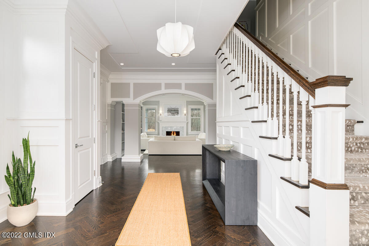 311 Stanwich Road Greenwich, CT 06830 - Photo 6 of 65 a view of a hallway with wooden floor and staircase