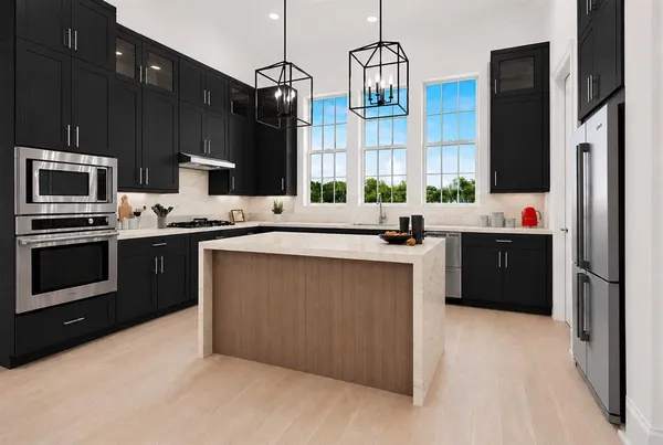 a kitchen with stainless steel appliances a sink stove and refrigerator