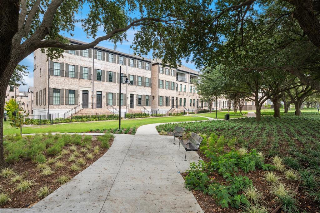 4080 Oak Street Addison, TX 75001 - Photo 16 of 19 a view of a brick building next to a yard with big trees