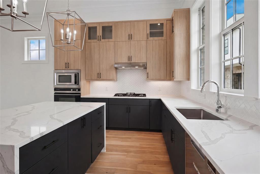 4080 Oak Street Addison, TX 75001 - Photo 2 of 19 a kitchen with stainless steel appliances granite countertop a sink stove and refrigerator