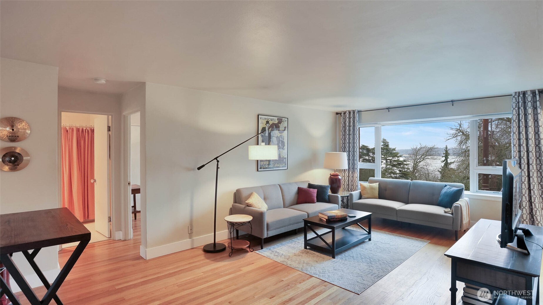 530 West Olympic Place, Unit 304 Seattle, WA 98119 - Photo 3 of 15 a living room with furniture and a large window