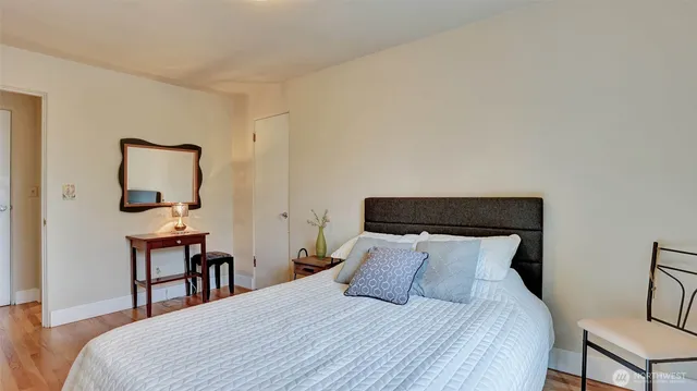 a bedroom with a bed a table and chair