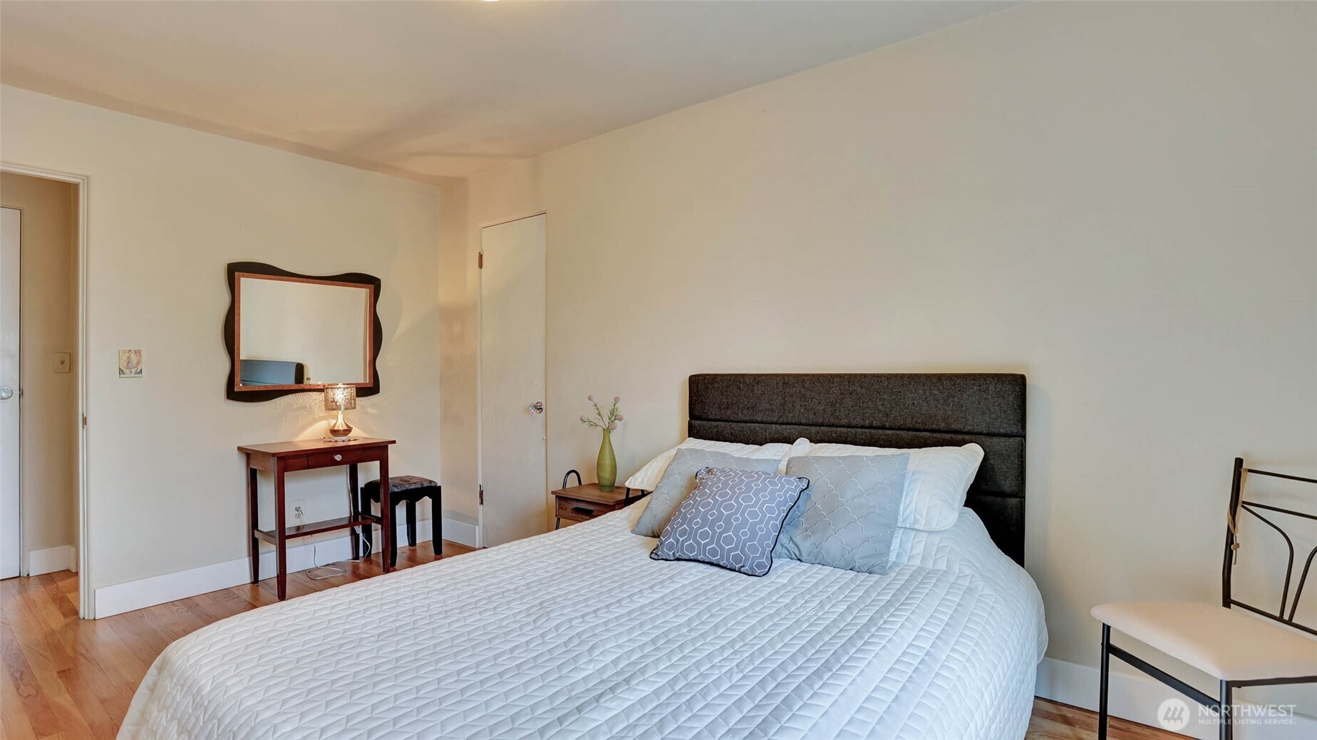 530 West Olympic Place, Unit 304 Seattle, WA 98119 - Photo 5 of 15 a bedroom with a bed a table and chair