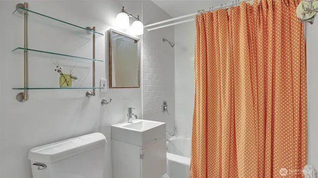 a bathroom with a shower curtain and a sink