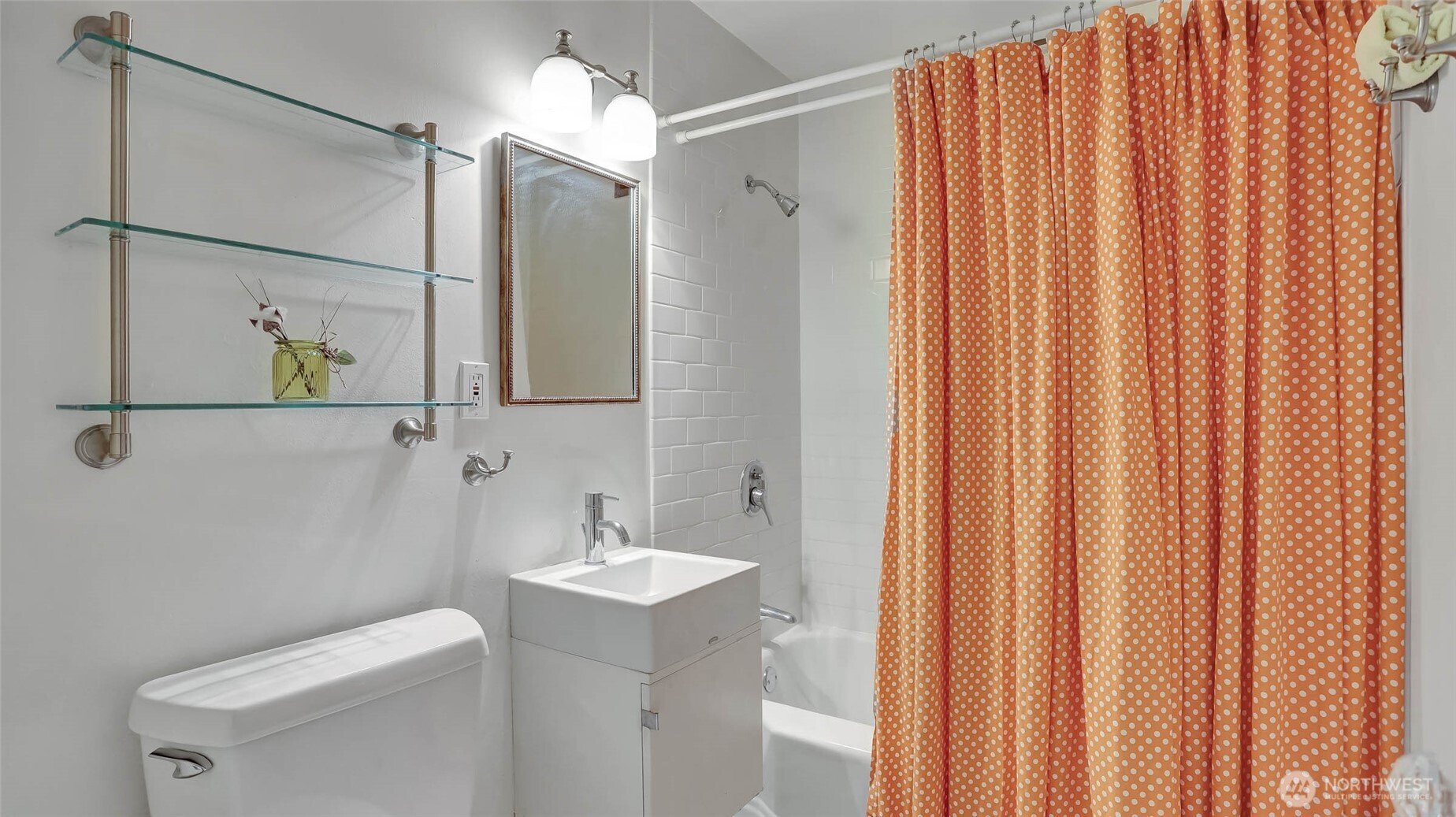 530 West Olympic Place, Unit 304 Seattle, WA 98119 - Photo 6 of 15 a bathroom with a shower curtain and a sink
