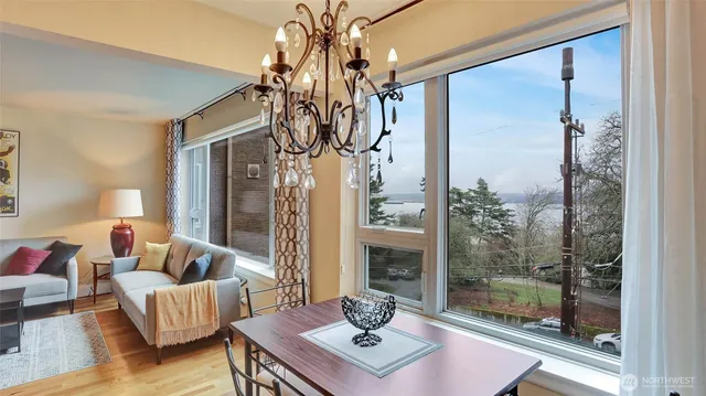 a living room with furniture and a chandelier